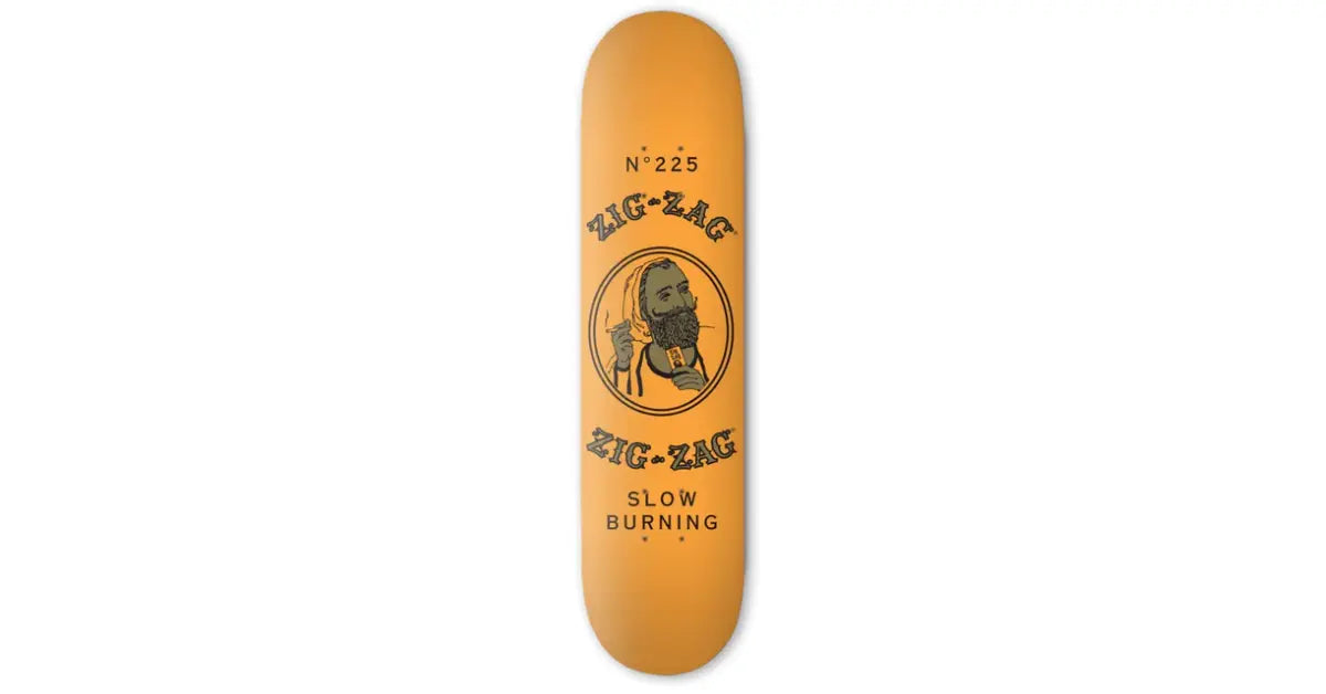 Zig-Zag skateboard deck in solid orange with "Slow Burning" text and vintage logo illustration.