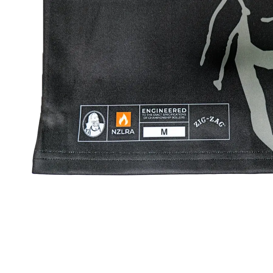 Close-up of a black Zig Zag jersey tag showing size M, NZLRA logo, and “Engineered for Championship Rollers” branding.