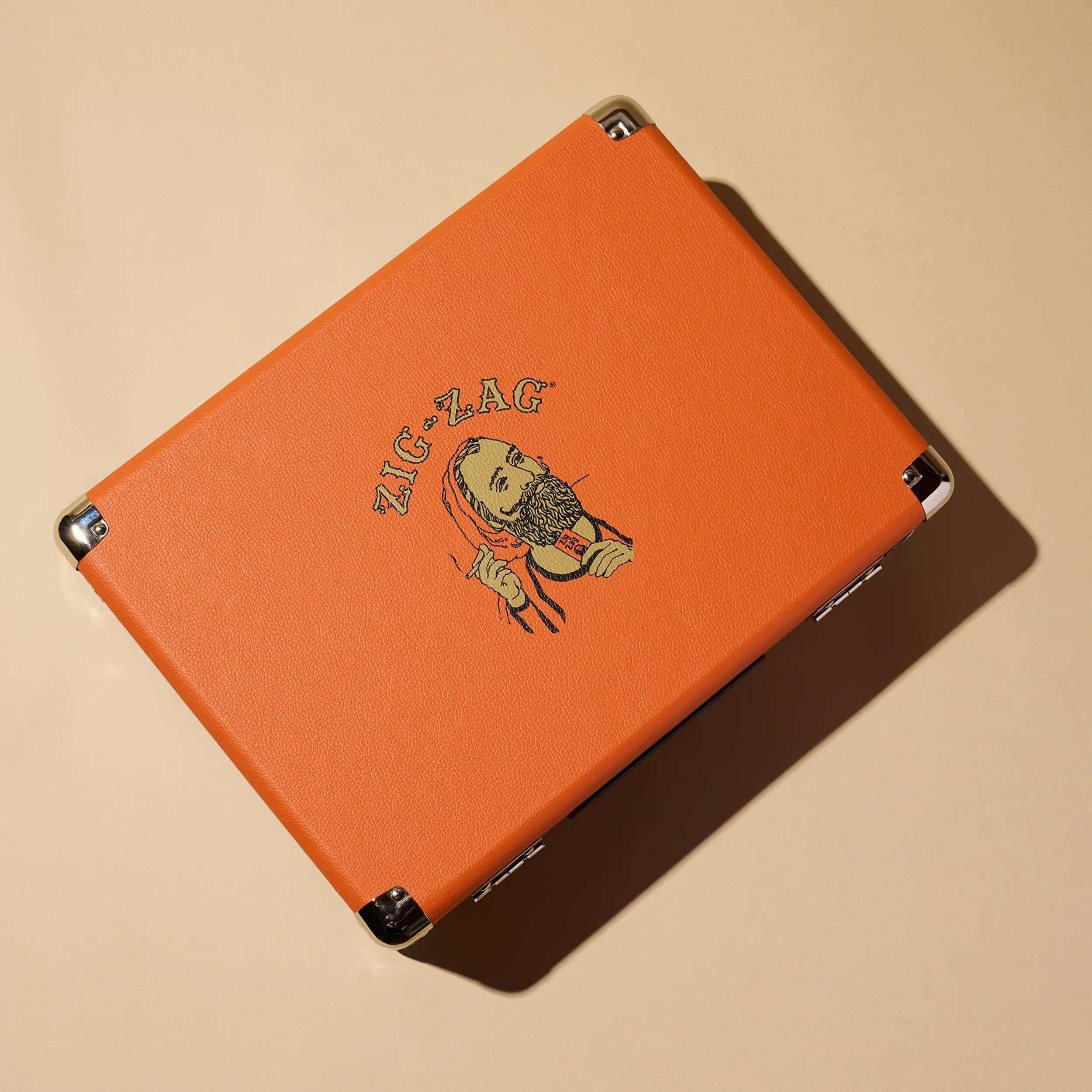 Zig Zag record player in orange leatherette casing with vintage logo artwork of a bearded man on the top lid.