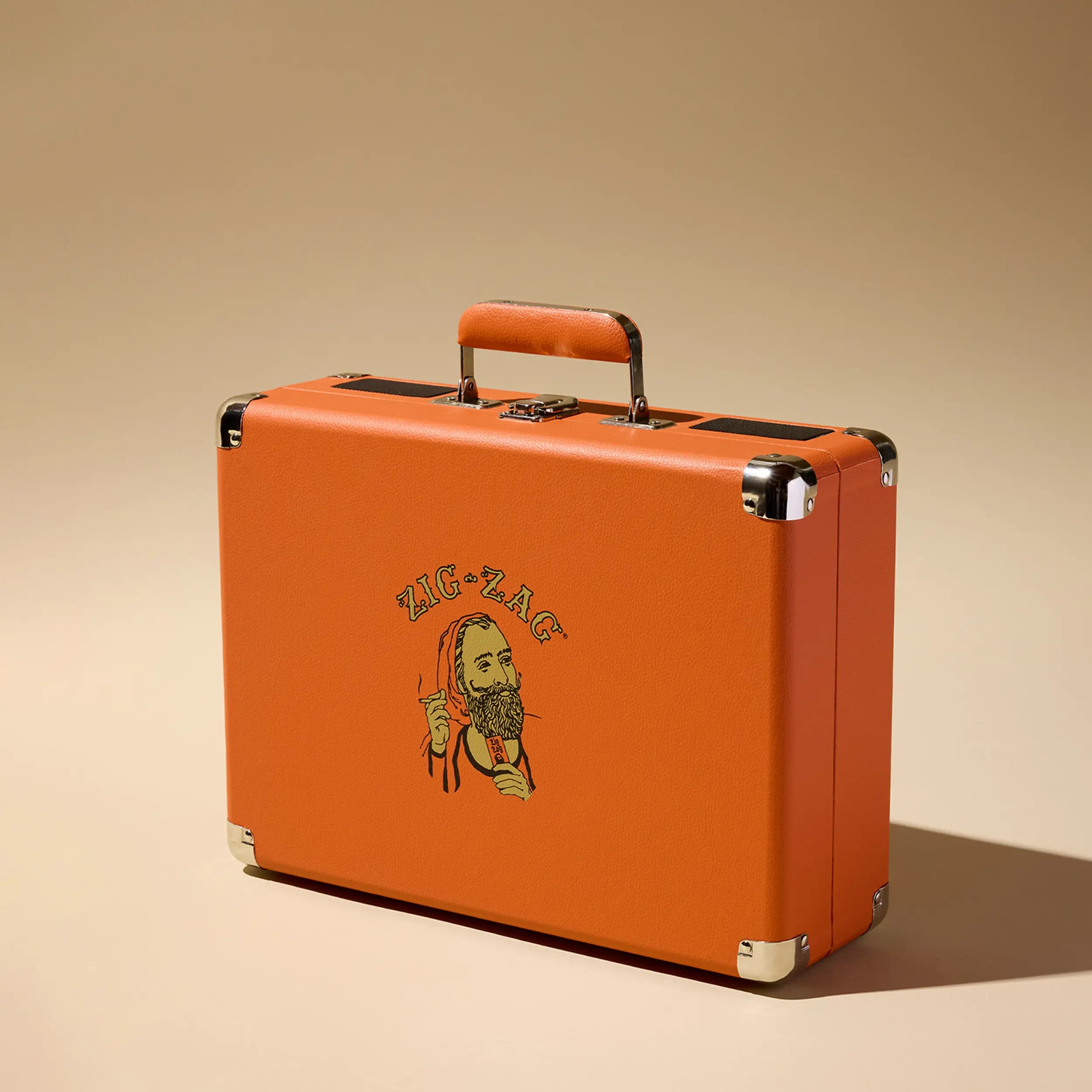 Zig Zag record player in a closed orange suitcase-style case featuring a vintage logo of a bearded man holding rolling papers.