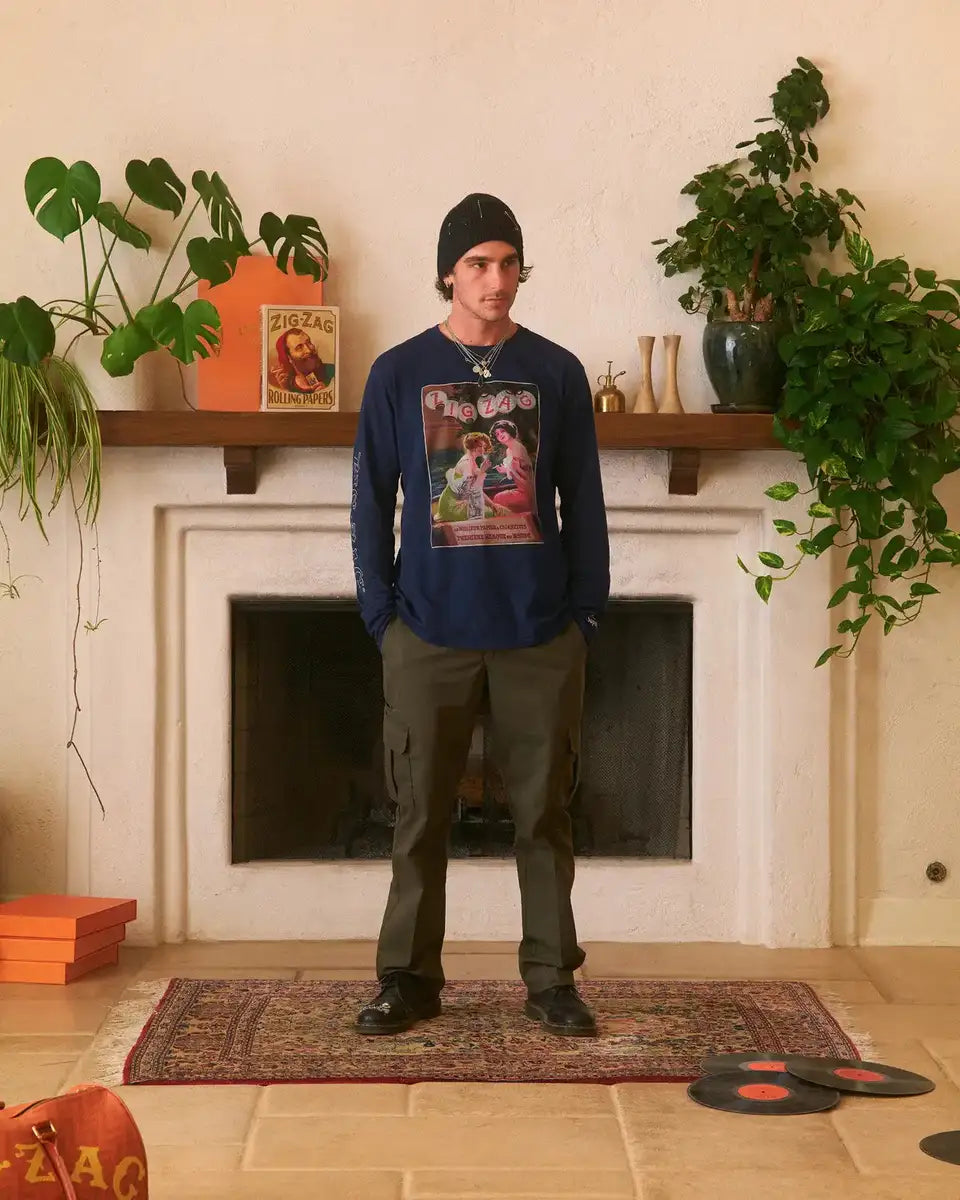 Zig-Zag long-sleeve navy shirt with vintage graphic worn by a person in a stylish room with plants, records, and decor.