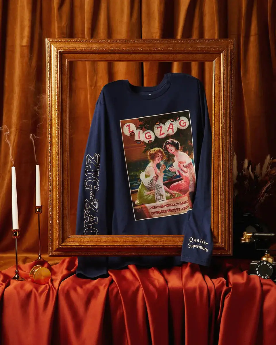 Zig-Zag long-sleeve navy shirt with vintage-style graphic and logo details, displayed in an ornate frame with elegant decor.