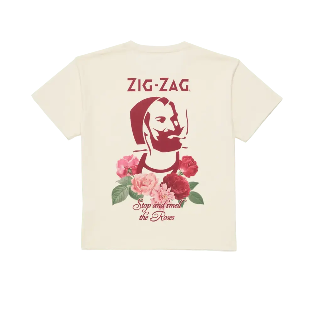 Cream-colored T-shirt featuring a stylized graphic of a bearded man, surrounded by red and pink roses, with "Zig-Zag" text and "Stop and smell the Roses" phrase underneath